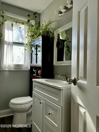a bathroom with a toilet sink and mirror