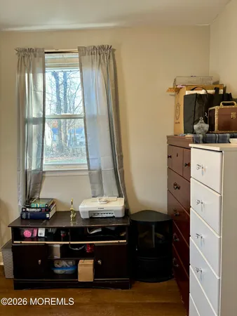 a view of room with window and cabinet