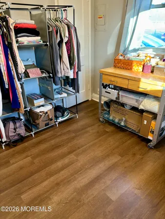 a view of walk in closet with clothes and shoes