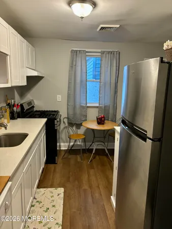 a kitchen with a sink appliances and cabinets