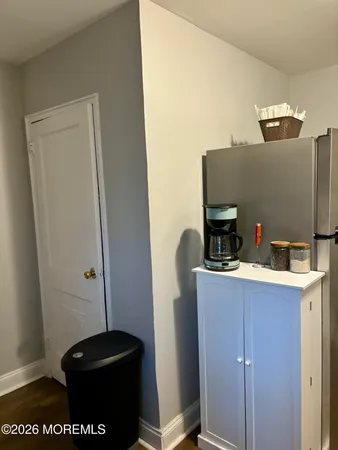 a view of kitchen hardwood and a refrigerator