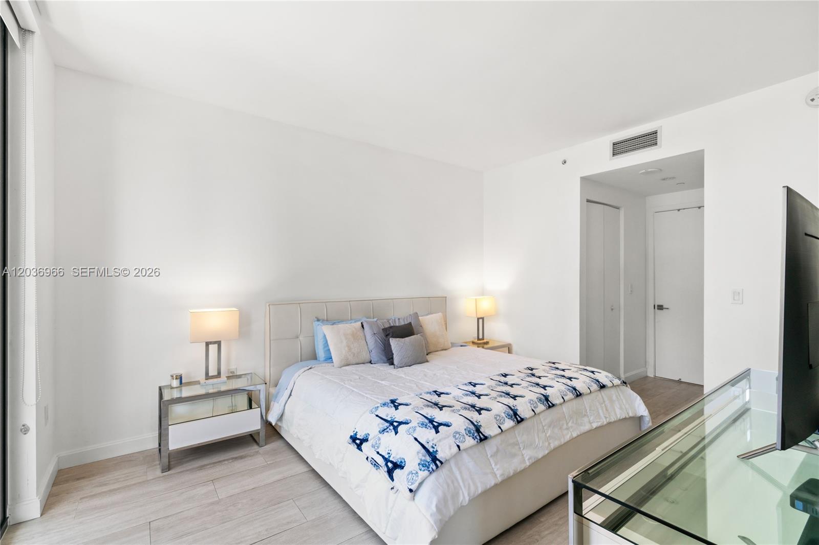55 Southwest 9th Street, Unit 1904 Miami, FL 33130 - Photo 36 of 66 a bedroom with a bed and a lamp