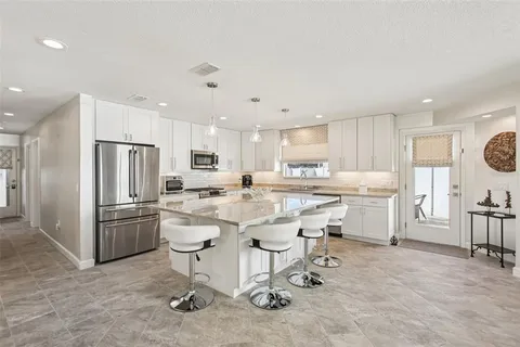 a dining room with furniture a chandelier and wooden floor