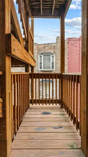 a view of a balcony with wooden floor