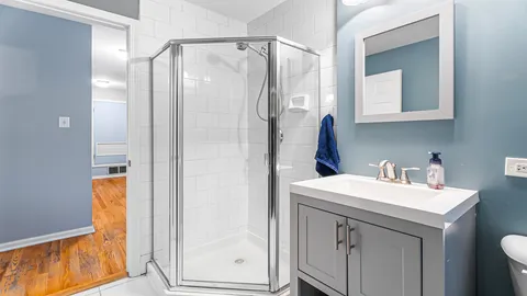 a bathroom with a sink a mirror and a shower