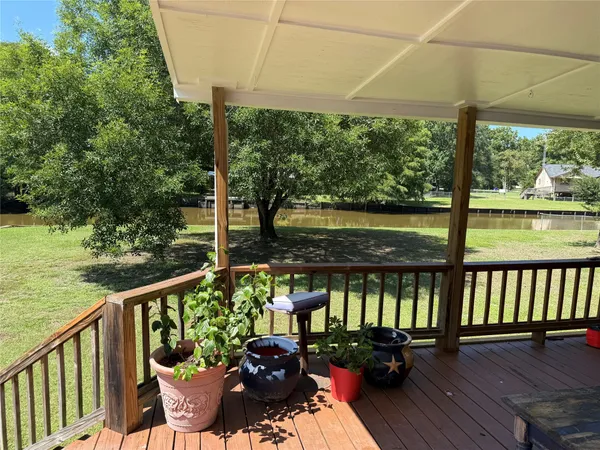 a view of a balcony with lake view and a potted plant