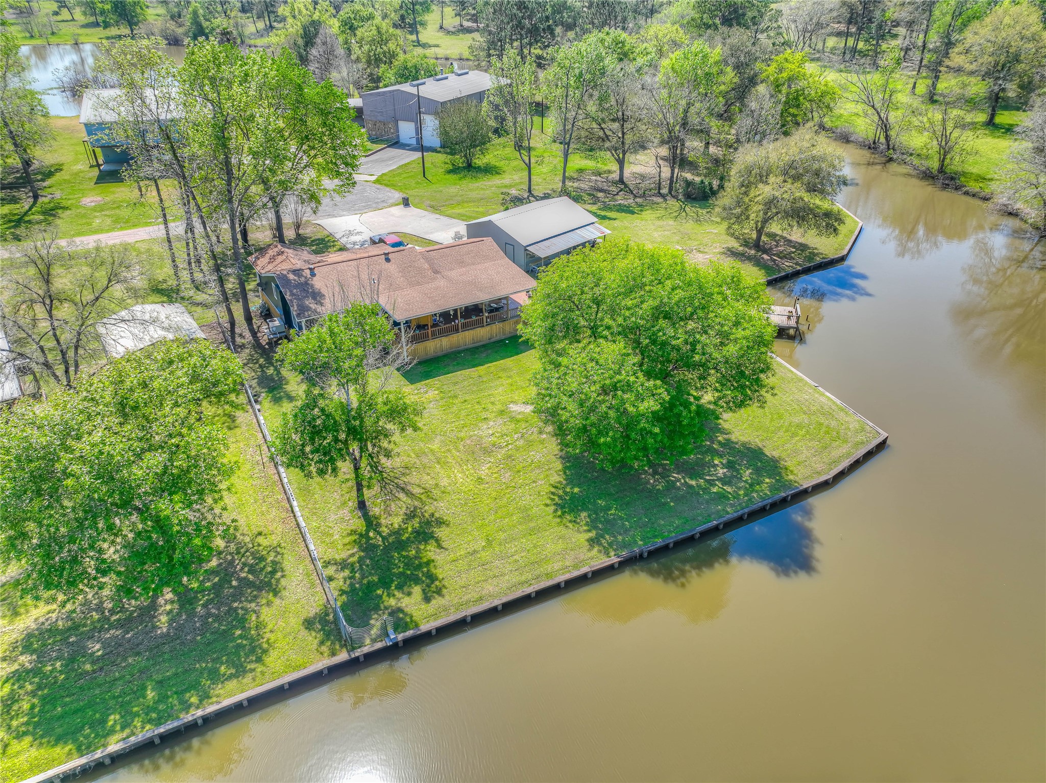 426 Deer Run Road Trinity, TX 75862 - Photo 14 of 18 an aerial view of a house with a garden and lake view