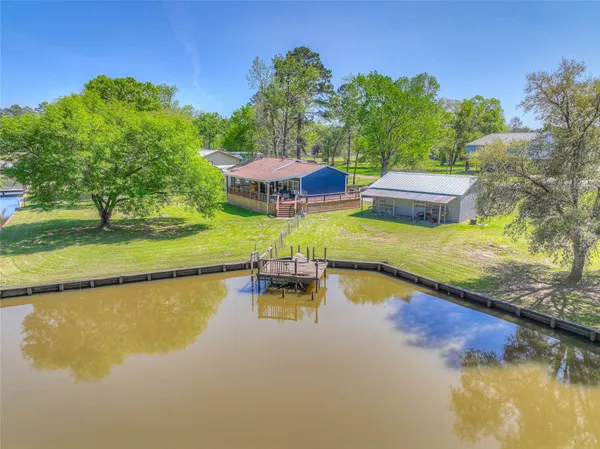 an aerial view of a house with swimming pool and outdoor space
