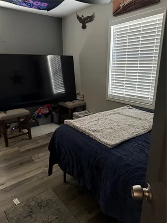 a bedroom with a bed and a television