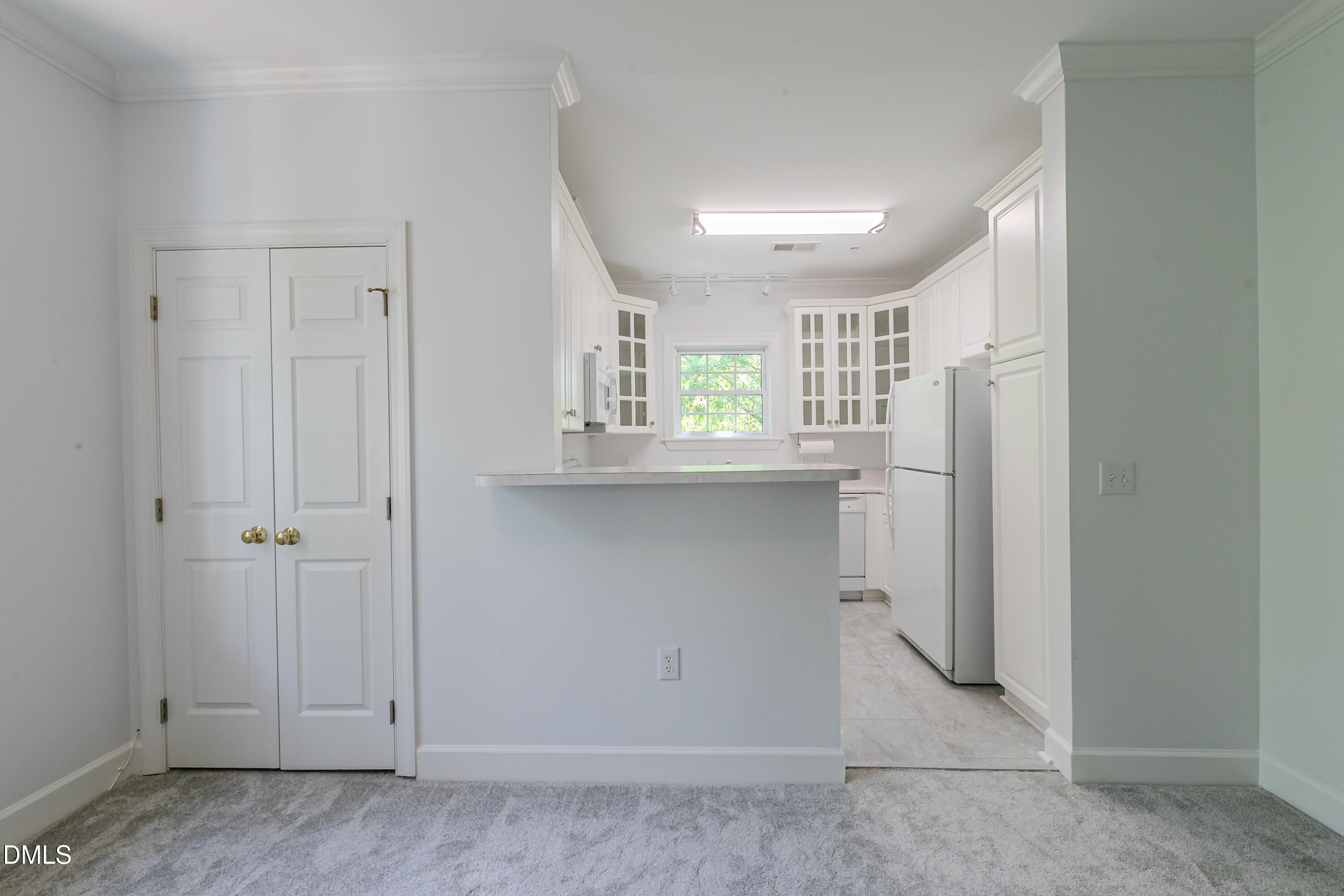 116 Northbrook Drive, Unit 305 Raleigh, NC 27609 - Photo 7 of 43 a kitchen with white cabinets and window