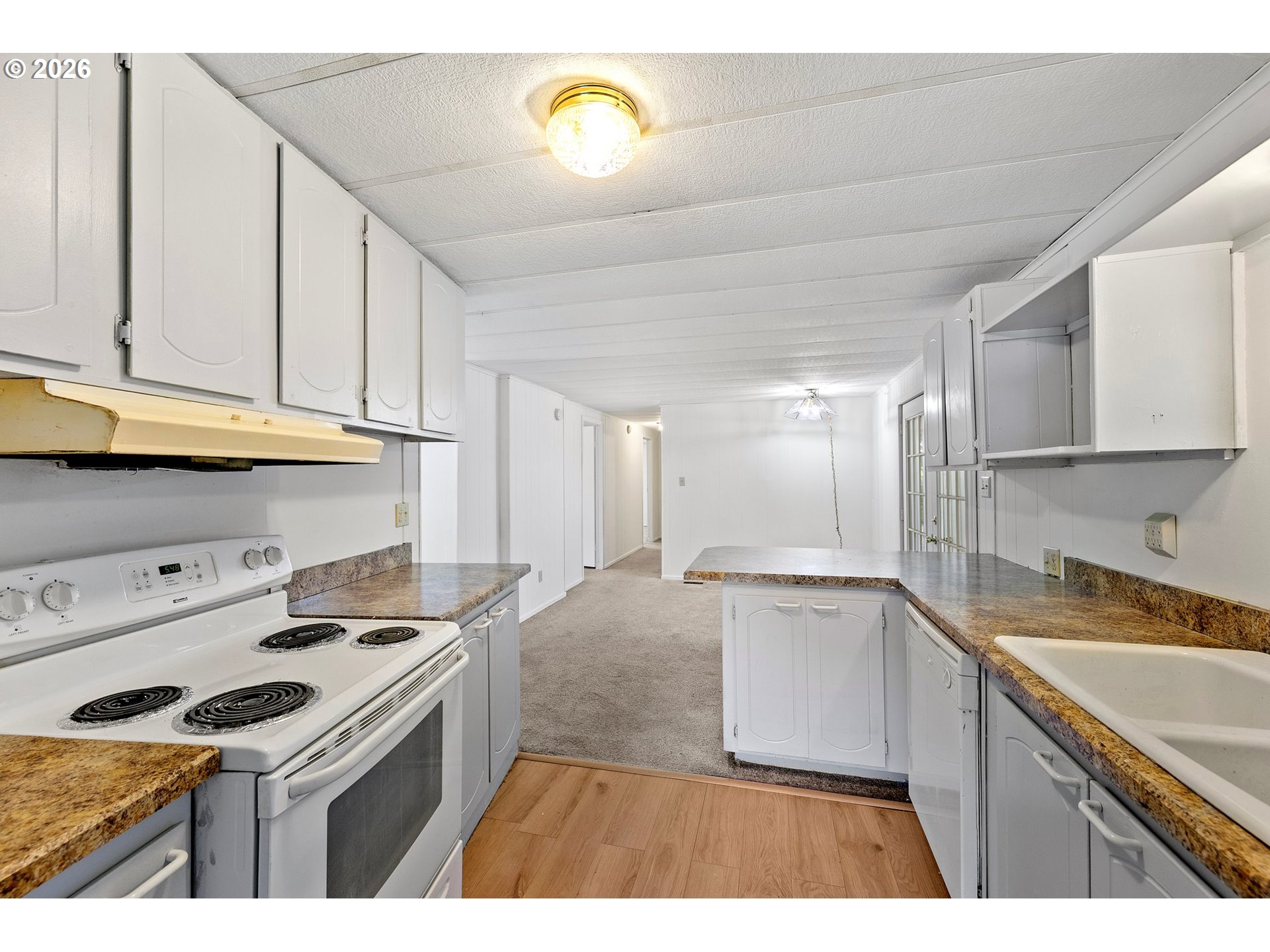 1600 Rhododendron Drive, Unit 429 Florence, OR 97439 - Photo 11 of 47 a kitchen with a sink cabinets and appliances