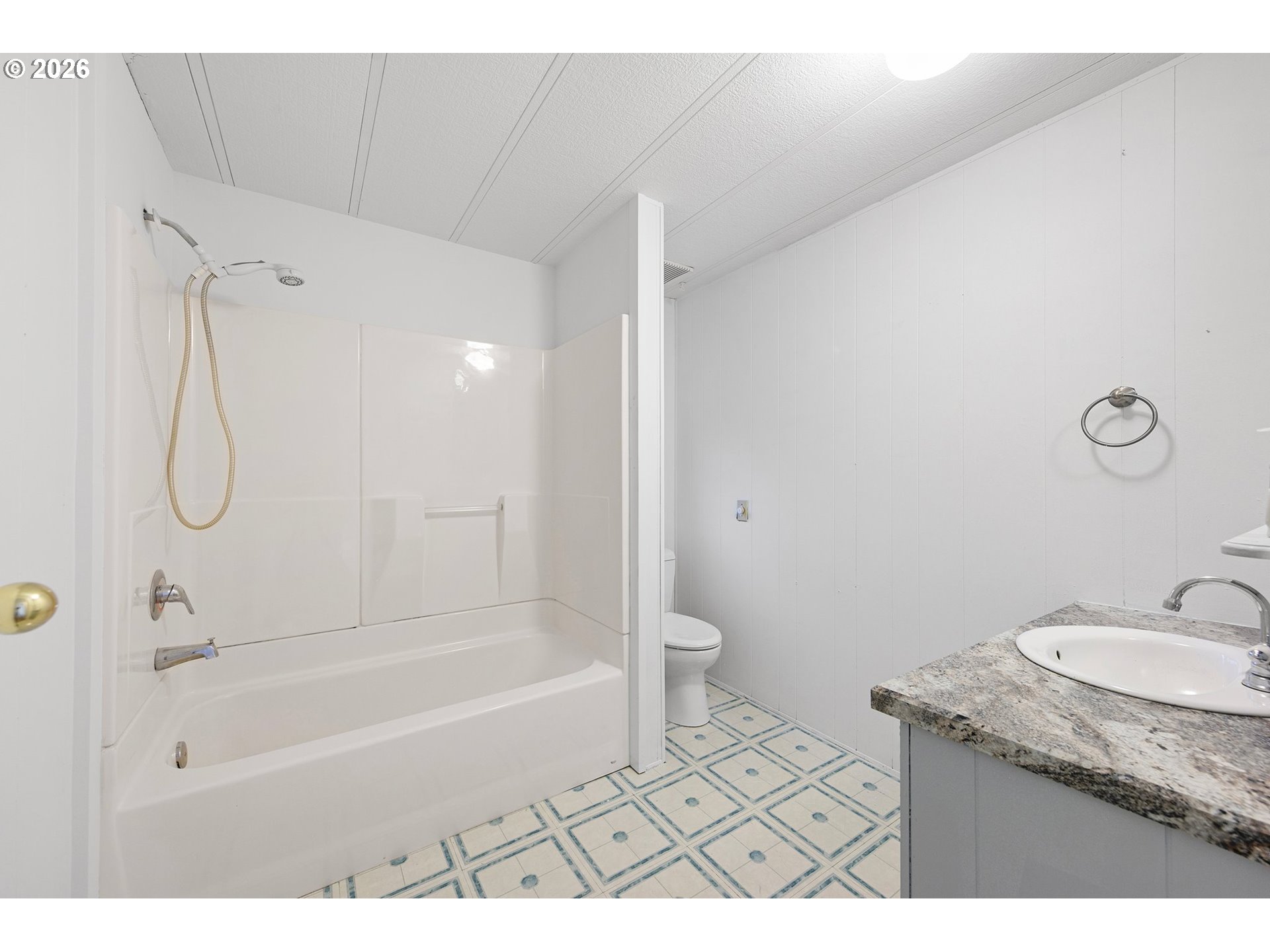 1600 Rhododendron Drive, Unit 429 Florence, OR 97439 - Photo 29 of 47 a bathroom with a granite countertop sink a toilet and a bathtub