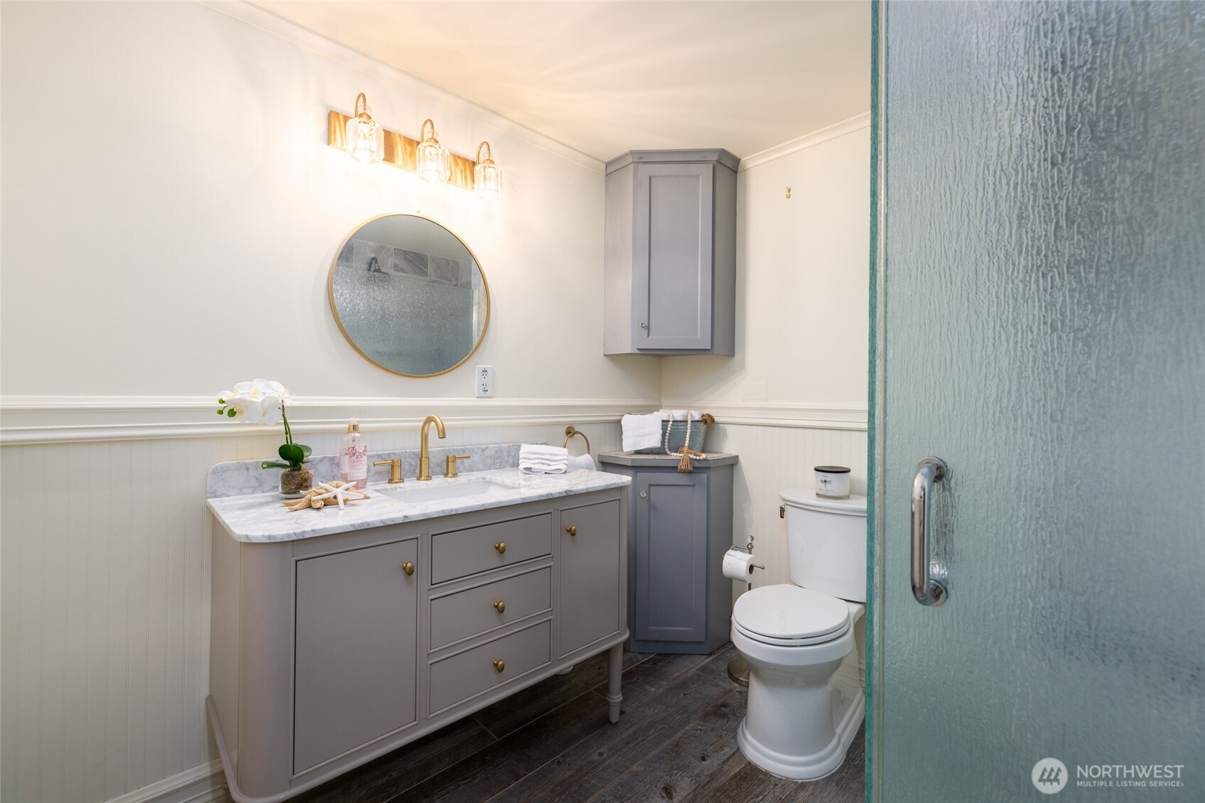 303 Benton Street La Conner, WA 98257 - Photo 19 of 40 a bathroom with a granite countertop toilet sink and mirror