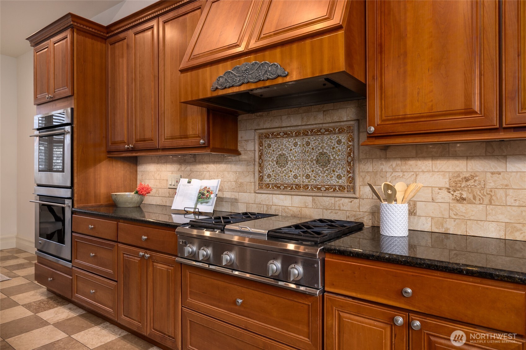 303 Benton Street La Conner, WA 98257 - Photo 32 of 40 a kitchen with granite countertop cabinets and stainless steel appliances