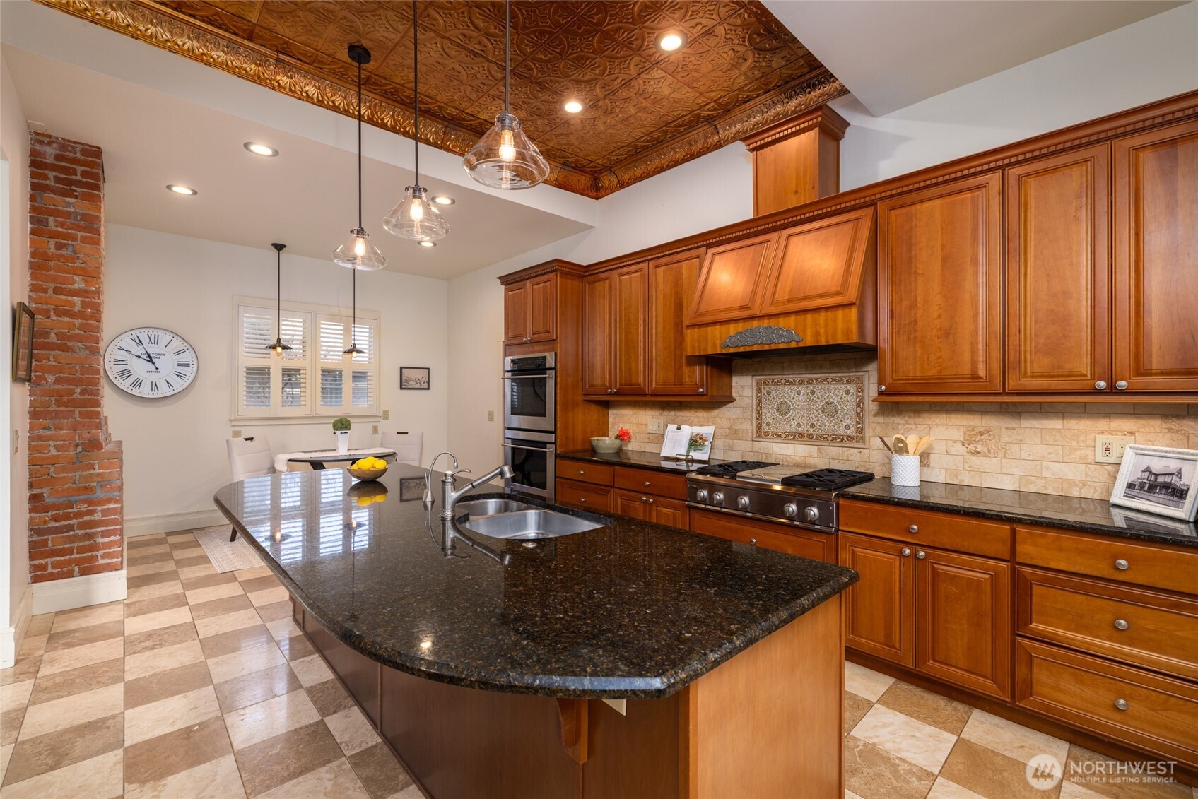 303 Benton Street La Conner, WA 98257 - Photo 9 of 40 a kitchen with stainless steel appliances granite countertop a sink a stove and a microwave