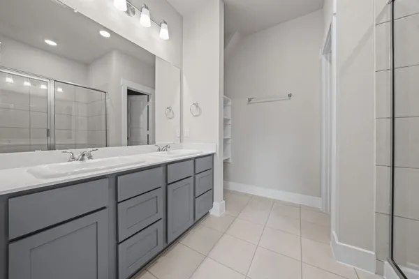 a bathroom with a double vanity sink and a mirror