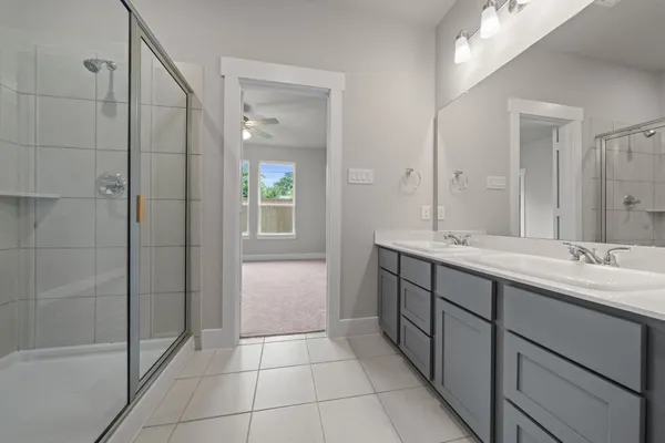 a bathroom with a double vanity sink and a mirror