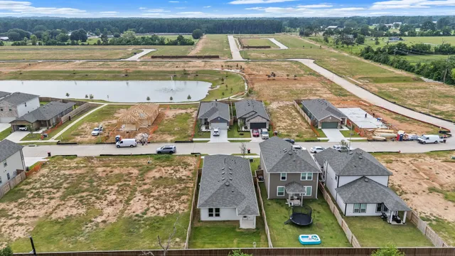 an aerial view of a house with a yard basket ball court and outdoor seating