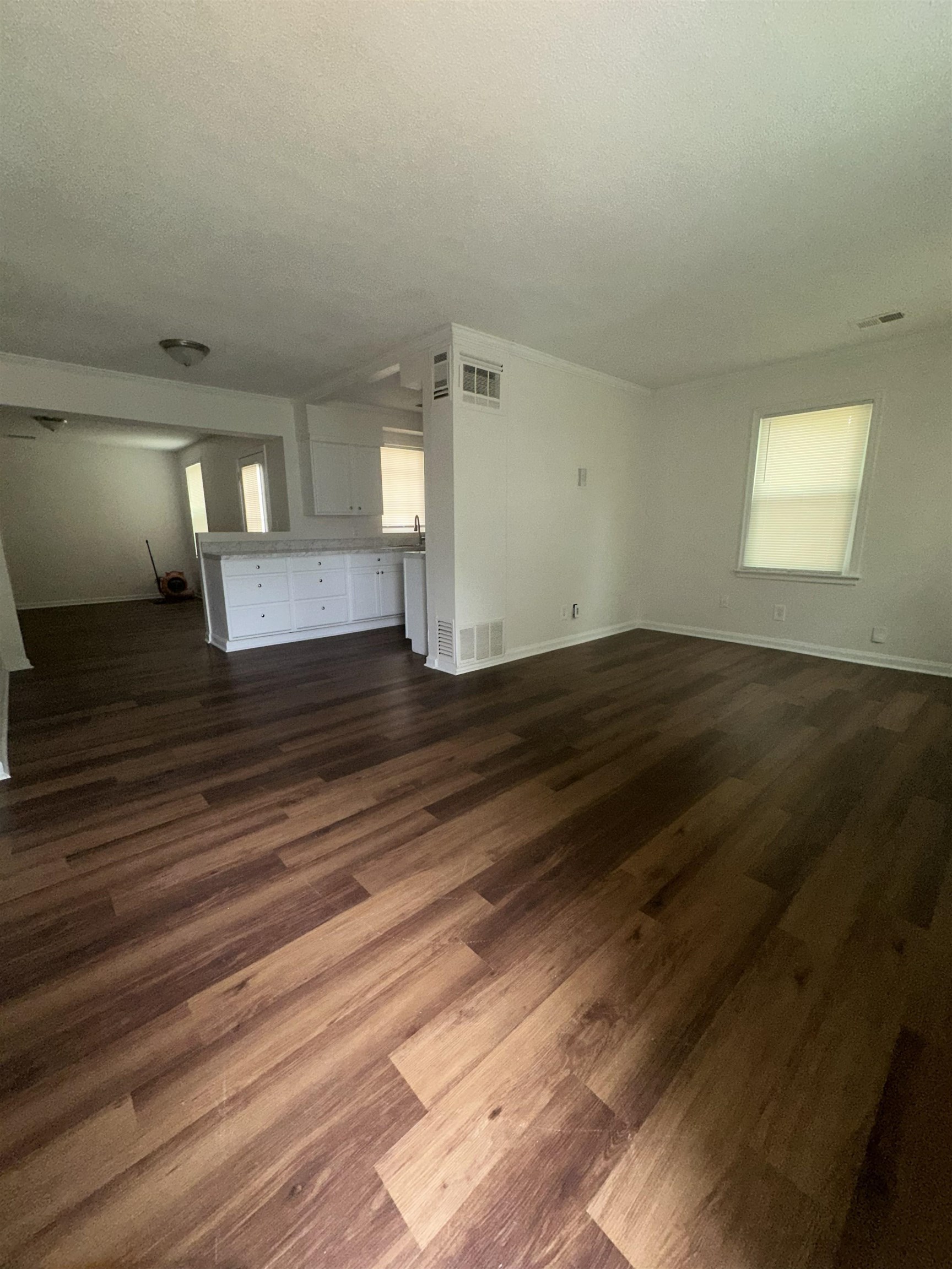 4545 Verne Road Memphis, TN 38117 - Photo 4 of 10 Open-concept living space featuring wood-finish flooring, white walls, and crown molding