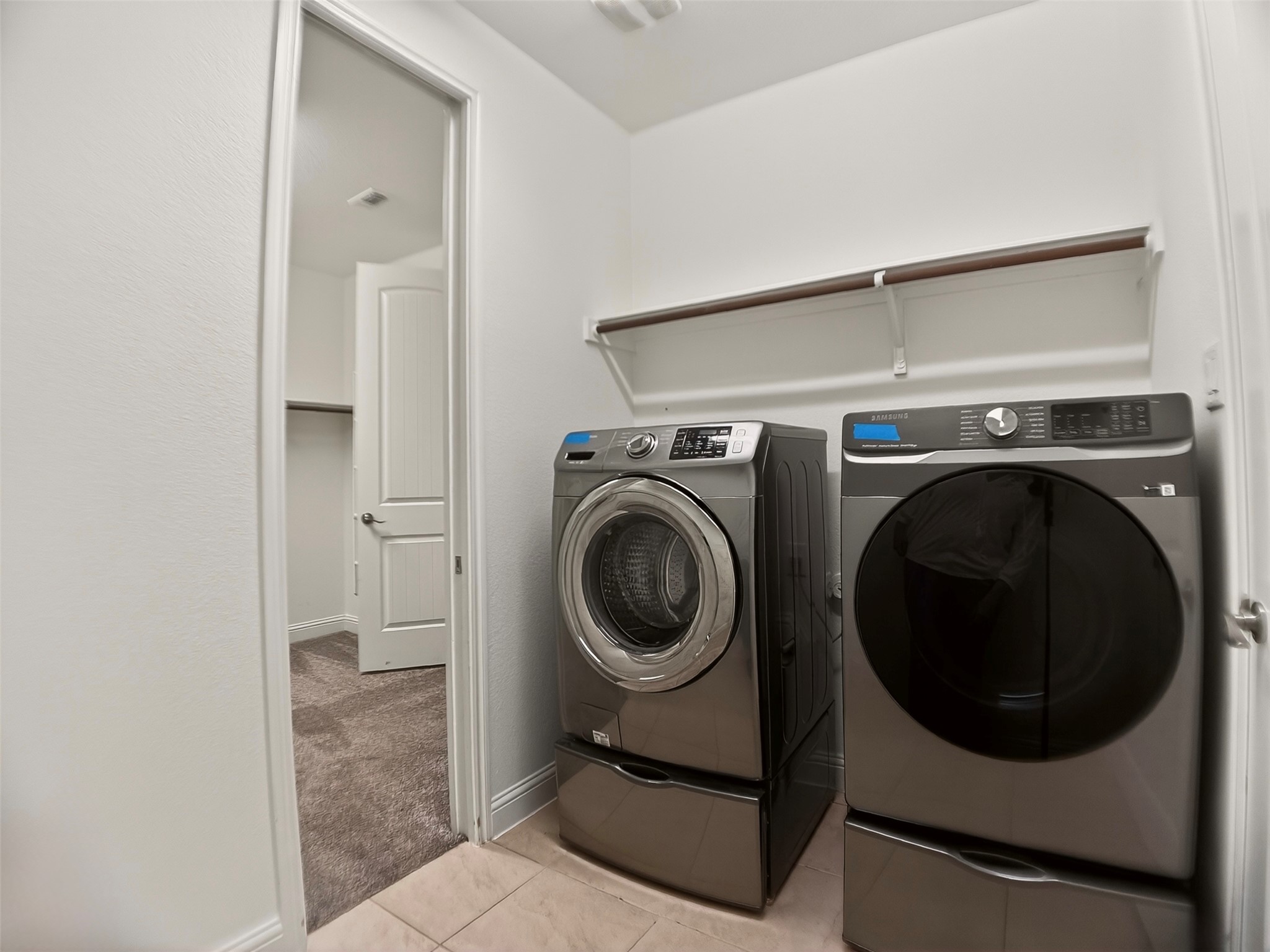 1505 Long Shadow Lane Georgetown, TX 78628 - Photo 8 of 28 Dedicated laundry space featuring tiled flooring and a built-in shelving unit with a hanging rod
