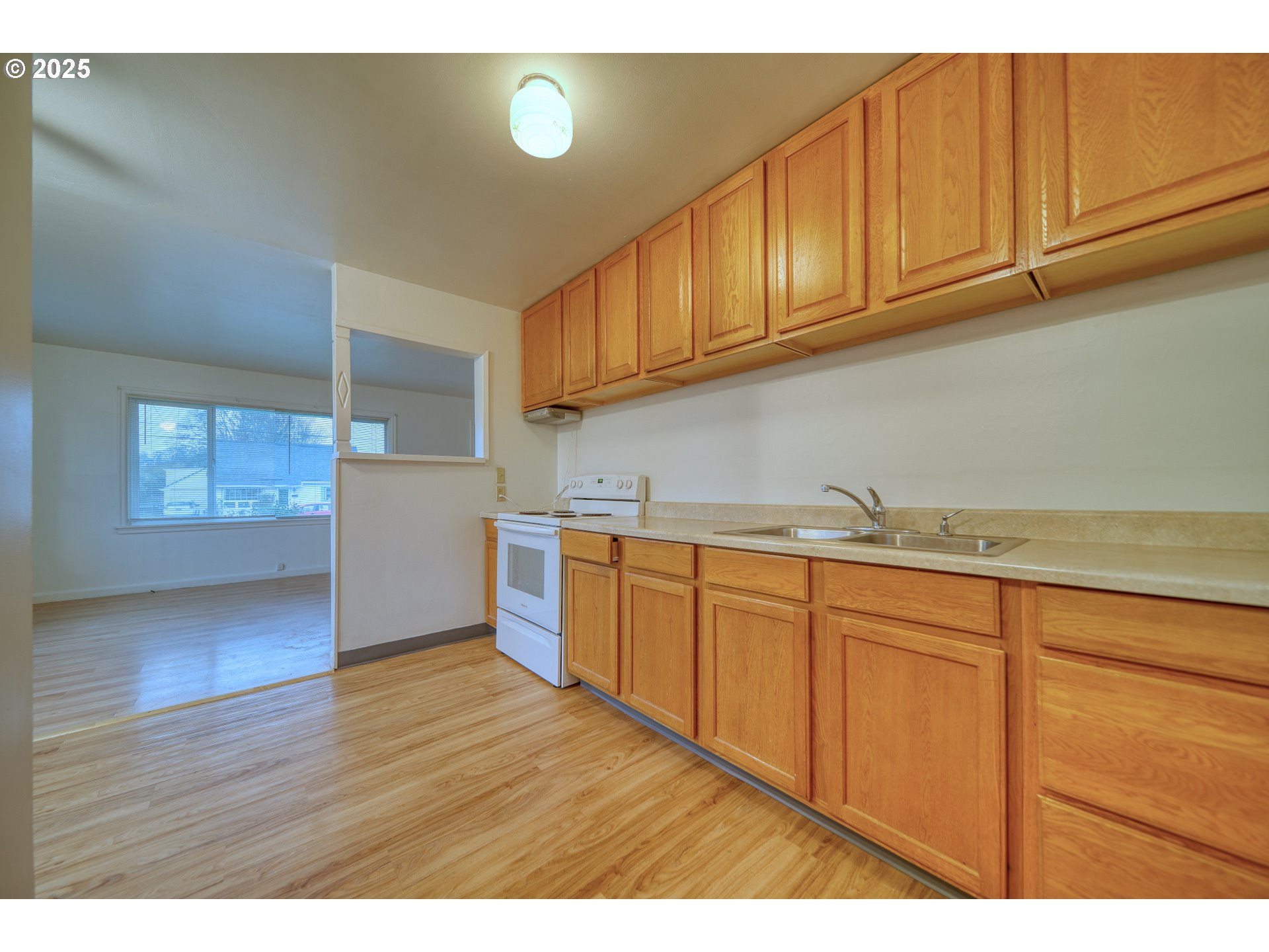 1924 Tualatin Street St. Helens, OR 97051 - Photo 16 of 27 a kitchen with granite countertop wooden cabinets a sink and dishwasher