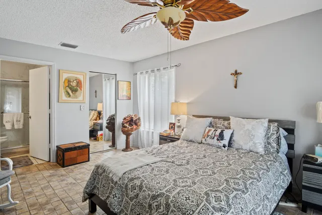 a bedroom with bed and glass door