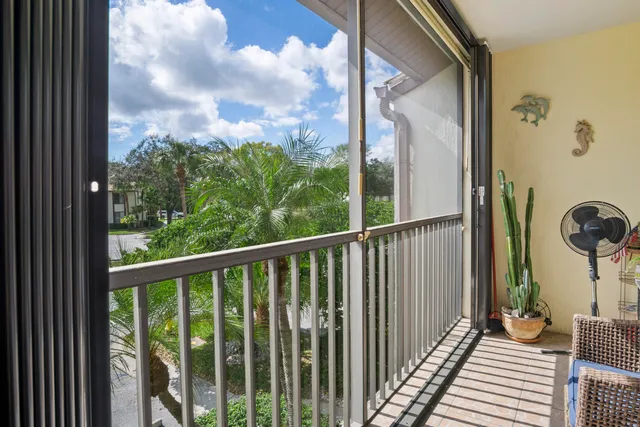a view of a balcony with wooden floor