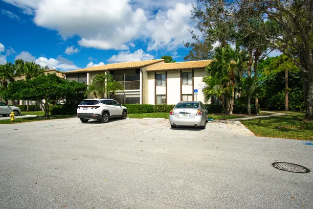 a car parked in front of house with a yard