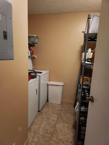 a view of storage and utility room with washer and dryer