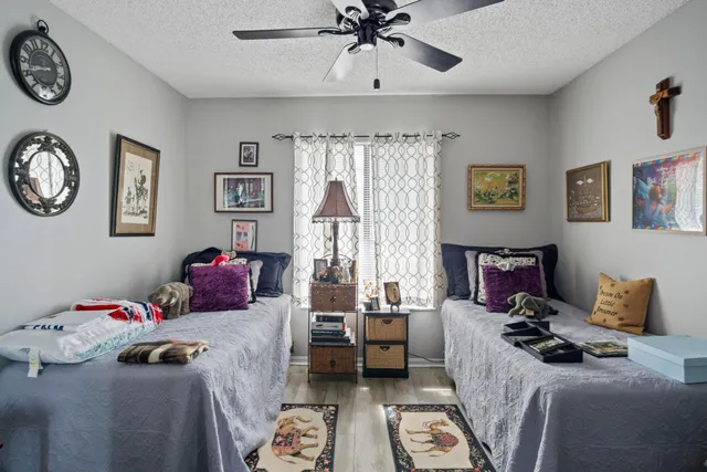 a bedroom with a bed and a chandelier