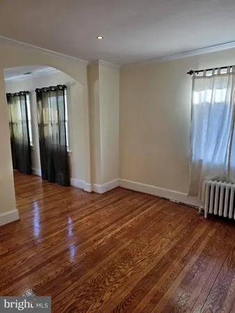 a view of a room with wooden floor and a window