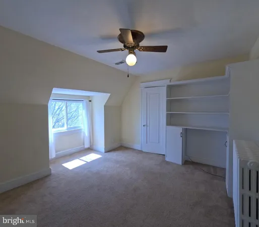 an empty room with wooden floor and window
