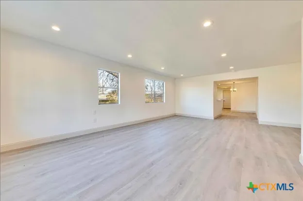 an empty room with windows and closet