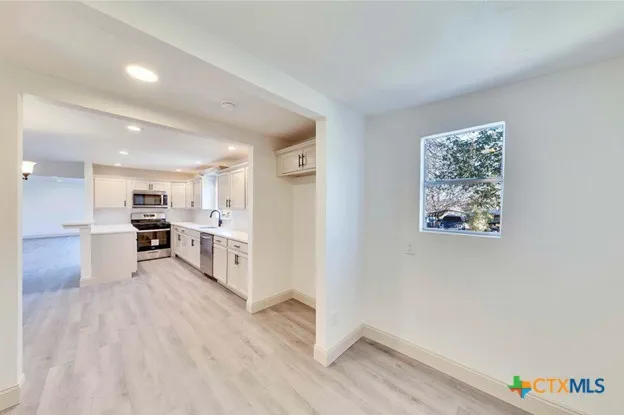 a view of kitchen with window and wooden floor