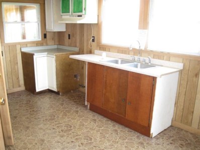 2945 Decatur Street Lake Station, IN 46405 - Photo 9 of 10 a kitchen with a sink cabinets and window