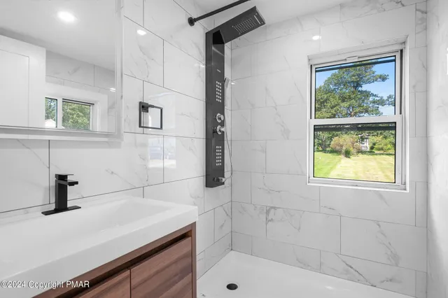 a bathroom with a sink a vanity and window