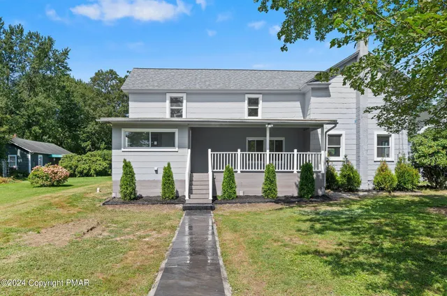 front view of a house with a yard