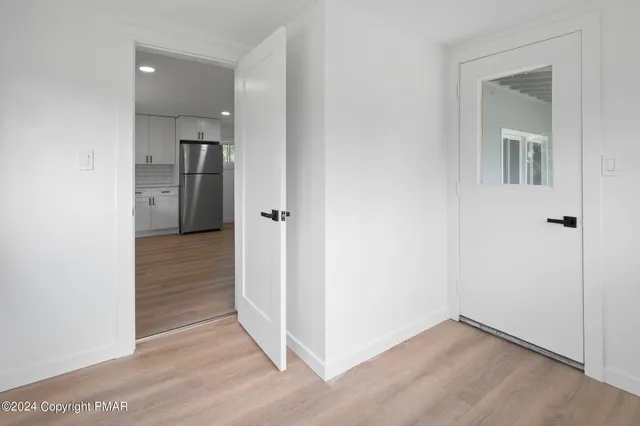 an empty room and wooden door