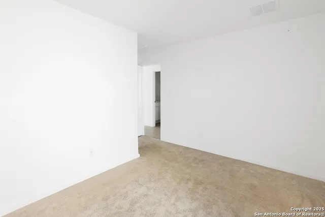 an empty room with windows and entrance