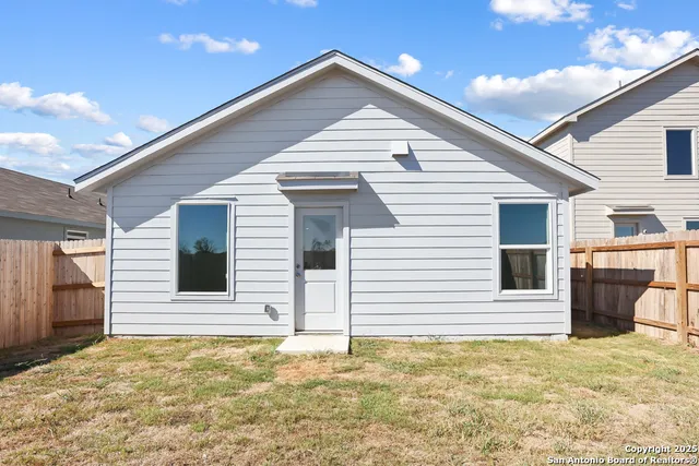 a view of a house with a backyard