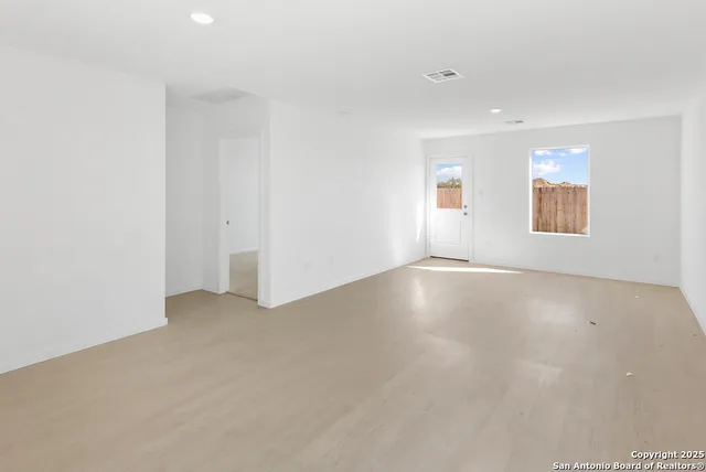 an empty room with a windows and closet