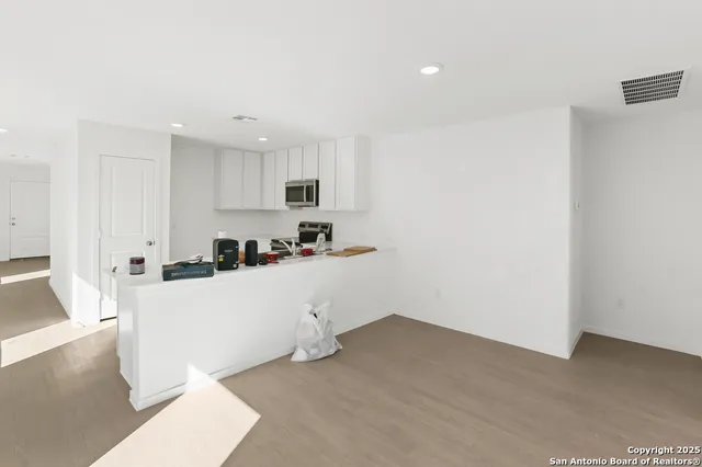 a kitchen with sink cabinets and microwave