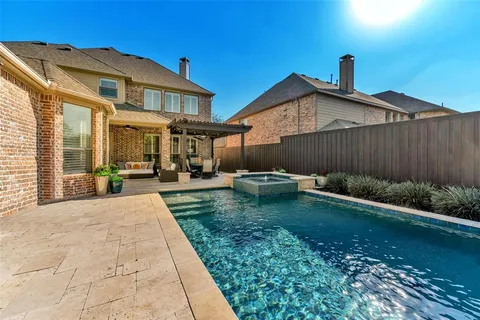 a backyard of a house with yard table and chairs