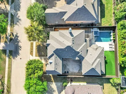 an aerial view of a house with a yard and a fountain