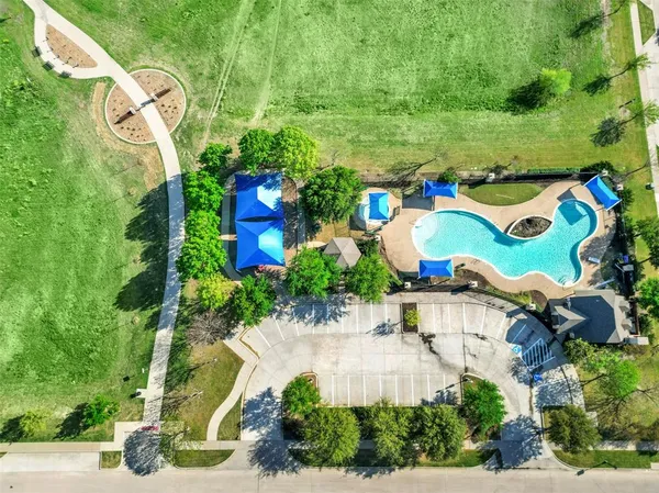 an aerial view of a house with a yard and outdoor seating