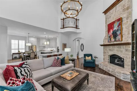a living room with furniture a fireplace and a wall painting