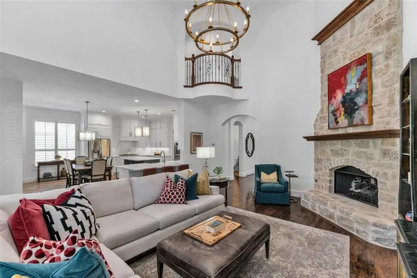 a living room with furniture a fireplace and a wall painting