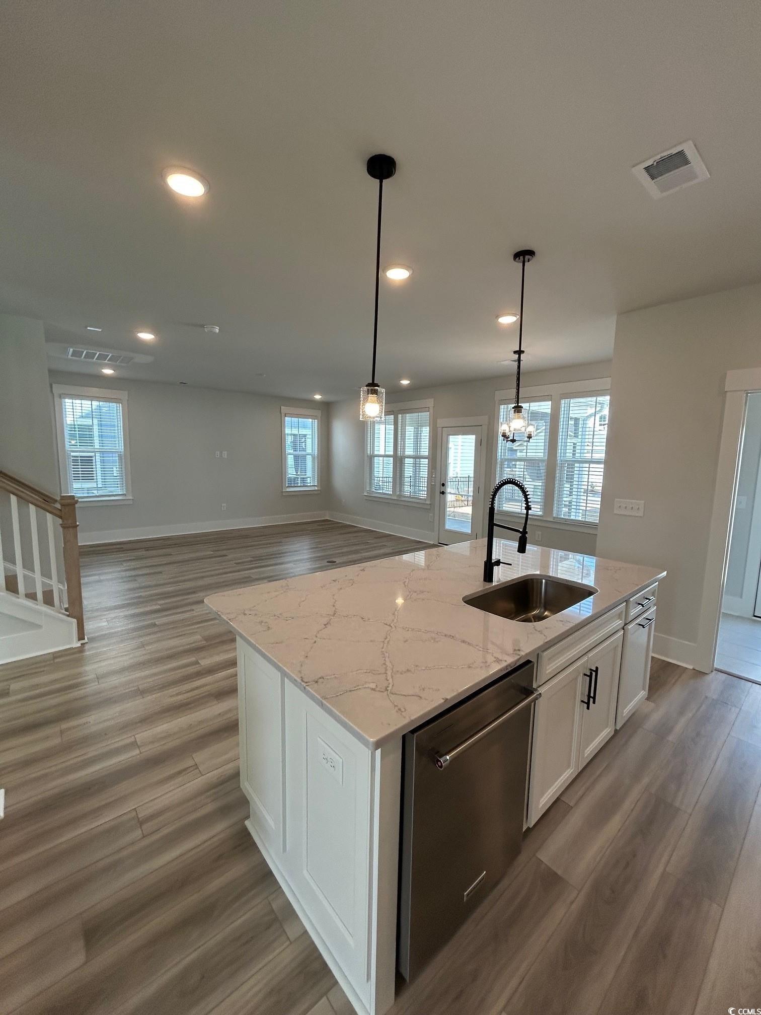 622 Braselton Lane Myrtle Beach, SC 29588 - Photo 5 of 15 Kitchen featuring light wood finished floors, visible vents, white cabinets, dishwasher, and a sink