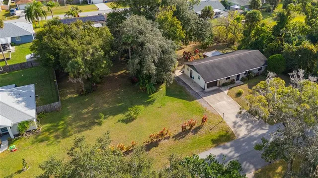 an aerial view of a house with a yard swimming pool outdoor seating and yard