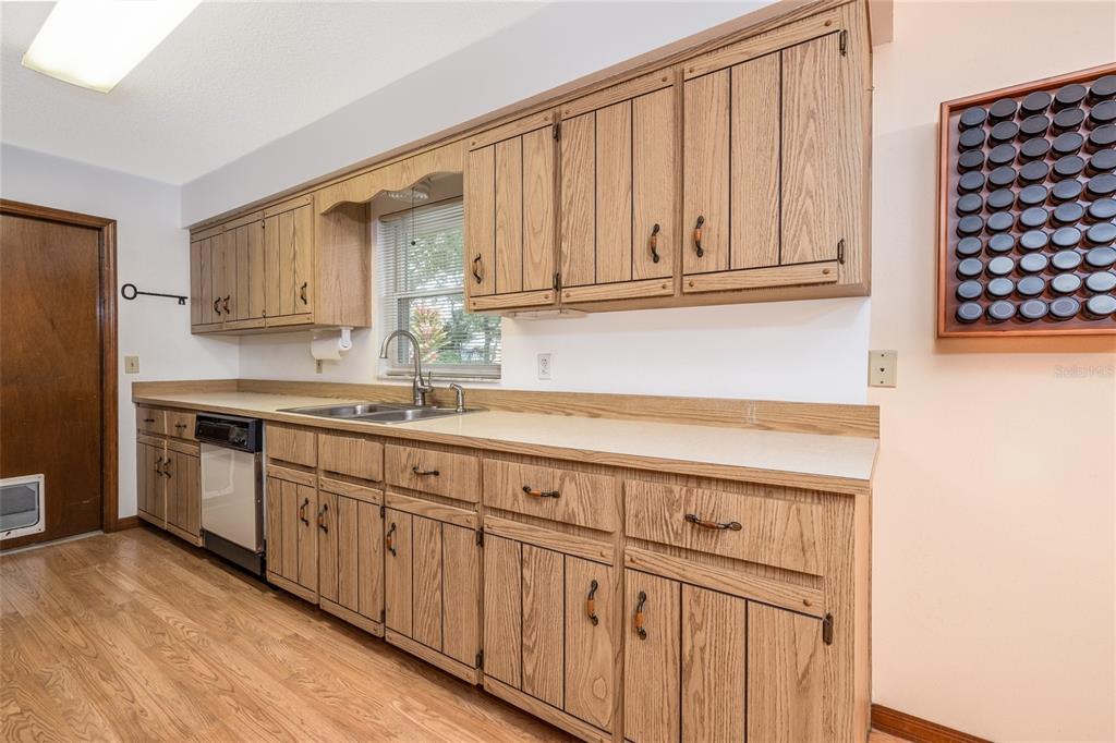 3221 Lime Tree Drive Edgewater, FL 32141 - Photo 16 of 28 a kitchen with granite countertop a sink cabinets stainless steel appliances and a window